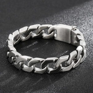 Macro view of silver Cuban chain bracelet with brushed steel finish and secure clasp