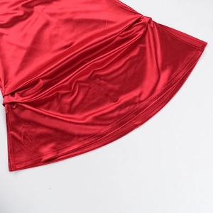 Close-up of elegant red satin fabric texture showing smooth glossy silk-like finish