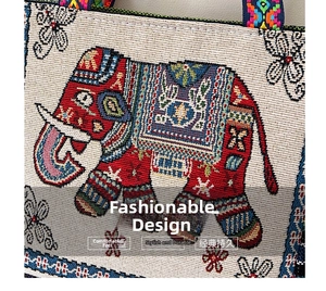 Close-up of ethnic embroidered tote bag with ornate red elephant and colorful strap