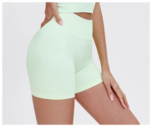 Detail view of mint green high-waisted seamless yoga shorts with ribbed compression waistband