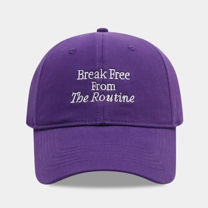 Detailed view of white embroidery text on a premium purple cotton baseball cap