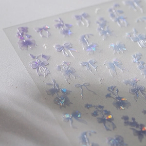 Holographic 3D bow and floral nail stickers with purple and blue metallic finish