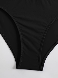 Detail view of double-stitched seams and elastic black fabric texture on high waist bikini