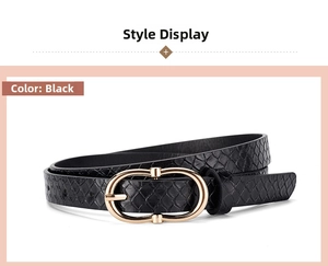 Detail of black faux leather belt with snakeskin texture and golden oval metal buckle