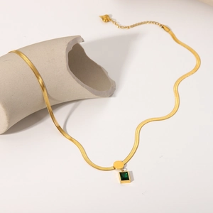Detail of 18K gold stainless steel snake chain necklace with green square zircon pendant