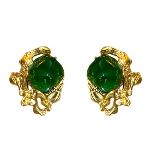 Vintage emerald green earrings with textured gold irregular metal frames on white background