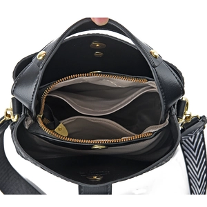 Black leather bucket bag with gold hardware and wide geometric shoulder strap