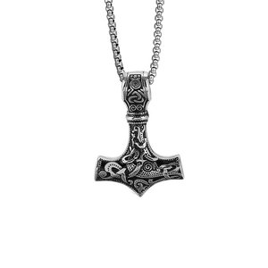 Macro shot of silver stainless steel Mjolnir pendant with intricate Nordic knotwork patterns