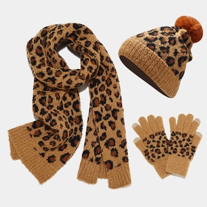 Detail of leopard print winter set showing knitted texture of scarf, hat and gloves