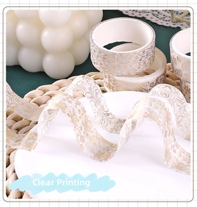 Detailed view of floral washi tape with gold foil stamping for DIY scrapbooking decor