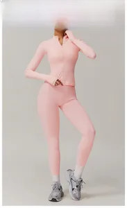 Detail view of peach pink yoga set featuring full-zip jacket and high-waisted leggings