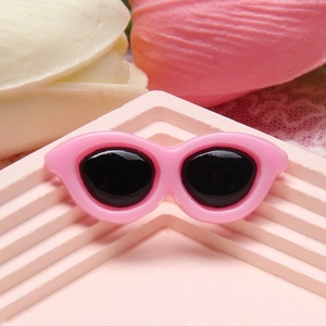 Close-up of a 4cm pink resin mini sunglasses accessory for DIY crafts and phone cases