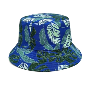 Detailed top view of navy blue bucket hat featuring tropical green leaf print patterns
