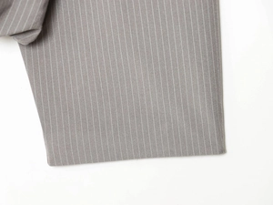 Detailed macro view of grey pinstripe fabric showing fine stitching and texture
