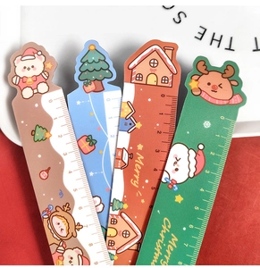 Detail of four colorful Christmas magnetic rulers with bear and reindeer patterns