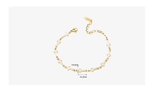 Detailed view of gold cross bracelet showing lobster clasp and adjustable extension chain
