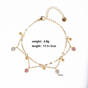 Detailed view of a gold-layered bracelet featuring pink heart zircon and metal sequins