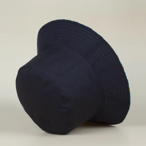 Close-up of black cotton fisherman hat featuring colorful geometric print reversible lining