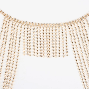 Detailed close-up of golden metallic chains with sparkling clear rhinestone fringe tassels