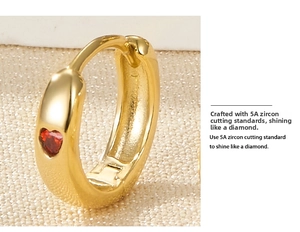 Macro view of gold huggie earring with premium heart-shaped red 5A zircon inlay