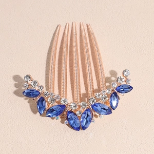 Detail of rose gold hair comb featuring blue marquise crystals and clear rhinestones
