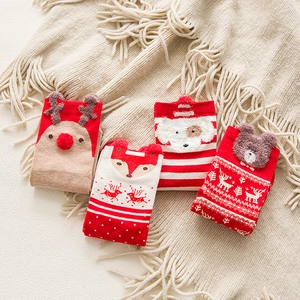 Detail showing plush Christmas socks with reindeer and dog 3D knit patterns