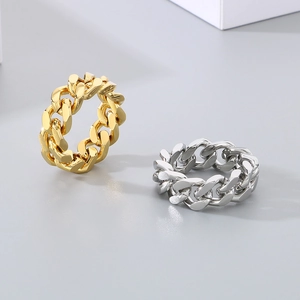 Detailed view of silver and gold punk Cuban link chain rings with polished finish