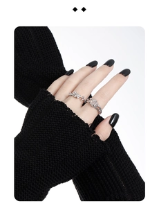 Detailed view of silver rings featuring hollow design and Tiger Eye stone on fingers