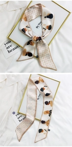 Detail of a beige silk hair ribbon with female portraits and diamond patterns