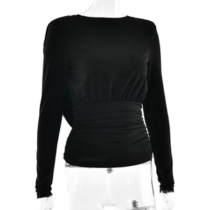 Detail view of black long sleeve backless top featuring side ruching on a mannequin