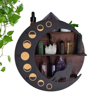 Detail of crescent moon wooden shelf with wolf silhouette for crystals and oils