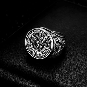 Detail of vintage signet ring featuring a 3D eagle crest with a black oxidized finish