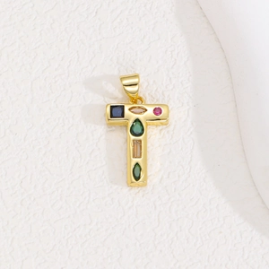 Macro detail of gold T-letter pendant featuring vibrant multi-color zircon stones