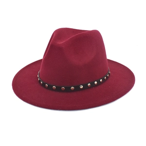 Detail of burgundy wool fedora featuring a black leather band with silver rivet studs