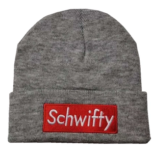 Close-up of gray knit beanie with red Schwifty embroidery and ribbed fabric texture