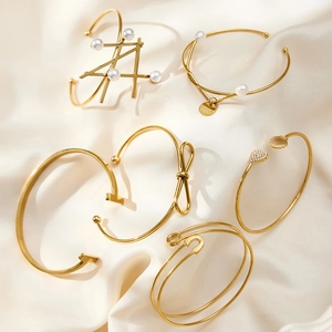 Minimalist 18k gold plated geometric bangle set with pearls and heart charms on silk