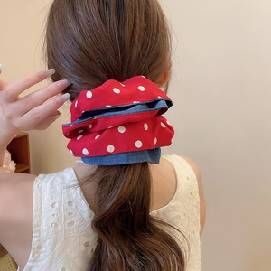 Close-up of a large double-layer polka dot and denim scrunchie on a ponytail