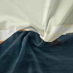 Detailed close-up of woven tapestry showing landscape print and soft fabric texture