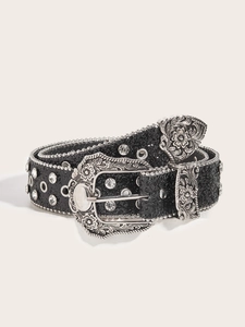 Detail of black glitter belt with silver carved buckle and rhinestone embellishments