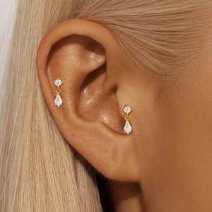 Close-up of S925 silver gold-plated stud earring with opal and zircon on model ear
