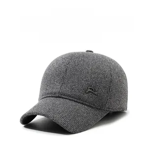 Close-up of grey winter baseball cap with ear flaps and metallic Sport logo detail