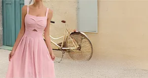 Detailed view of pink pleated summer dress featuring square neckline and hollow-out detail