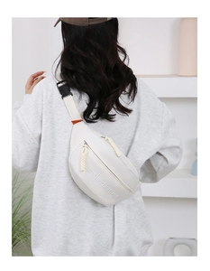 Rear view of model wearing white canvas chest bag showing practical capacity and fit