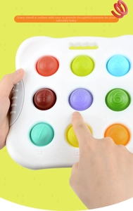 Detail of infant sensory toy with colored silicone buttons featuring numbers and braille