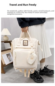 Detail of multi-functional diaper backpack with cupcake charm and decorative text patch