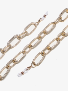 Detail of the hammered texture on thick golden aluminum eyewear chain with silicone loops