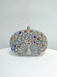 Detail of colorful peacock rhinestone evening clutch with sparkling gemstone metal clasp
