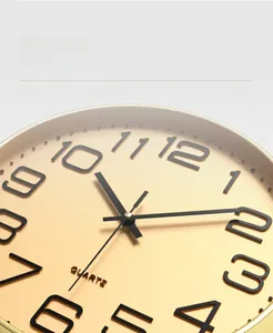 Detailed macro view of brushed gold dial with black 3D numerals and quartz movement