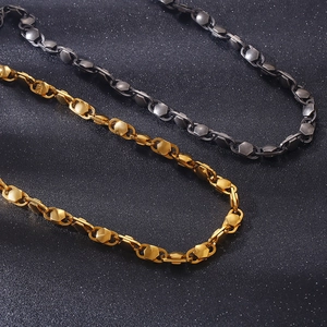 Detail of hexagon chain links in gold and black titanium steel for men's jewelry