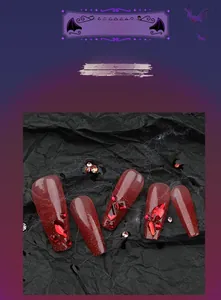 Macro detail of long coffin Halloween nails with dark red glitter and rhinestone accents